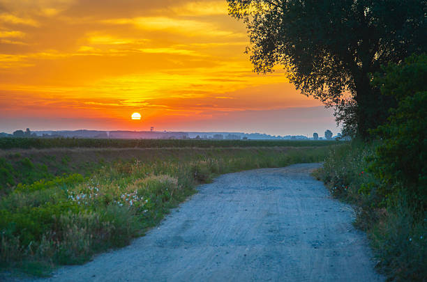 Sunrise by the canal with water near the village