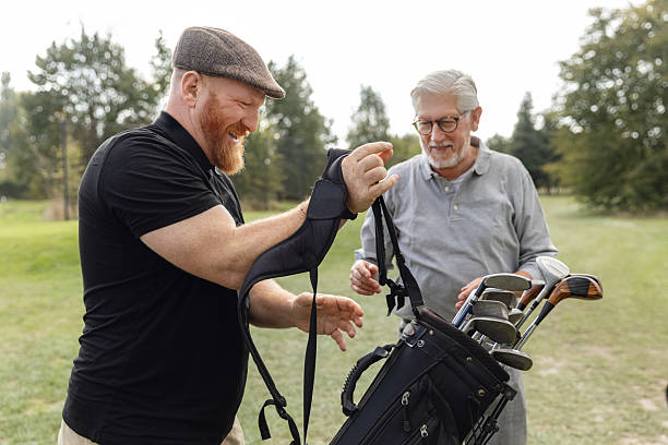 istock Senior retired man and his caddy playing golf in Europe 2239135725