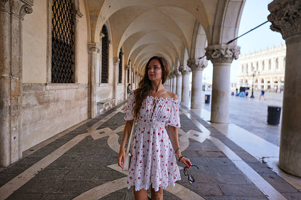 istock Woman walking under historic arcade Venice Italy 2239136612
