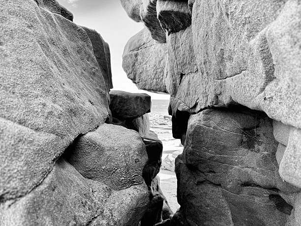 A narrow gap between rock formations on a beach in Northumberland
