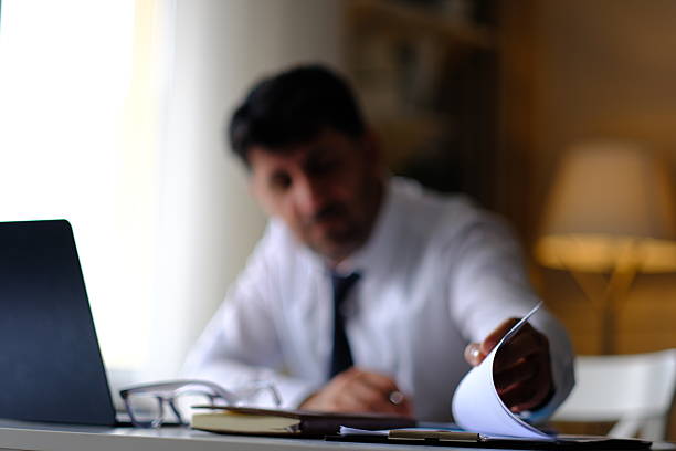 Businessman trying to find a document on his desk