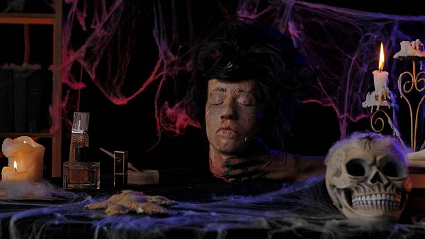 istock Scary zombie hands hold a severed dead head 2239150229