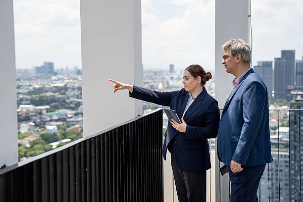 istock Two business people use tablet computer at rooftop office and city background 2239151246
