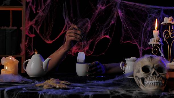A luxurious tea set with a golden floral teapot and cup, basking in the natural outdoor sunlight.