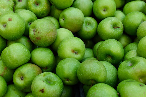 istock Fresh green apples piled in a market display 2239154321