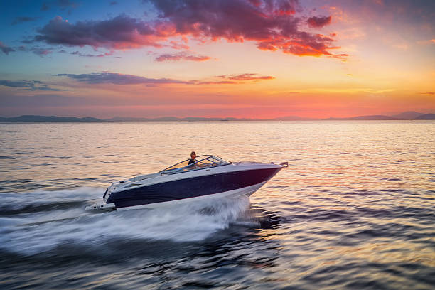 istock A motorboat sails ove the calm ocean with high speed during sunset time 2239165156