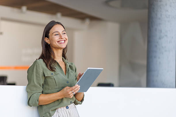 istock Confident businesswoman smiling and using digital tablet in office 2239165877