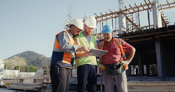 istock Civil engineer, foreman and master are discussing on the progress plan and the project at construction site 2239171243
