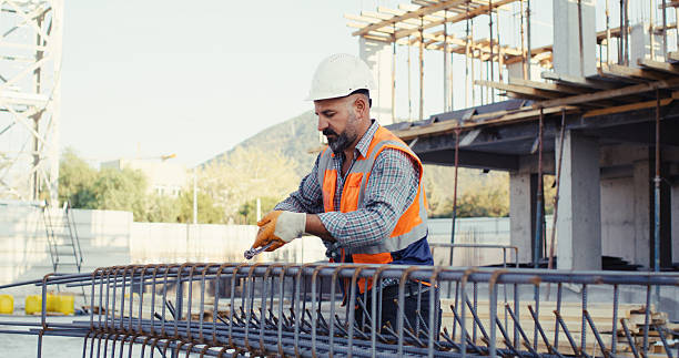 istock Construction master wiring steel reinforcement cage for columns at construction site 2239171696