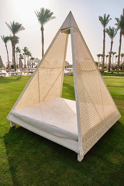 istock White pyramidal retreat tent on a grass. 2239172966