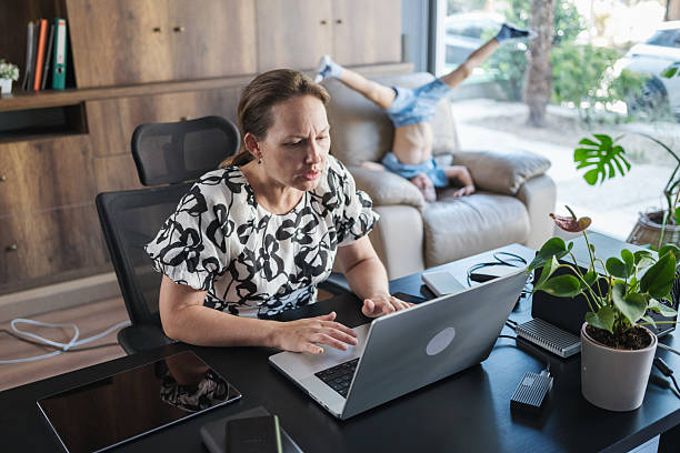 istock Child boy distracting his mother working at home 2239173465