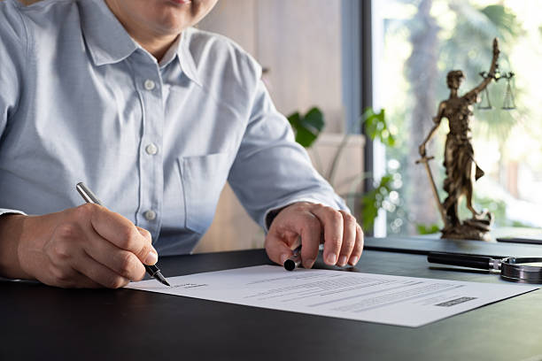 istock Lawyer signing an official document in the office 2239174059