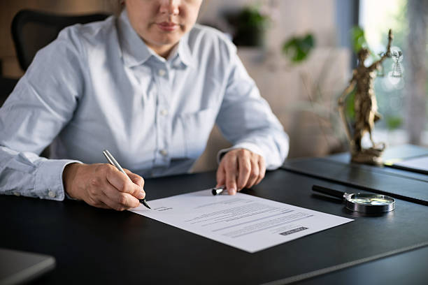 istock Lawyer signing an official document in the office 2239174106