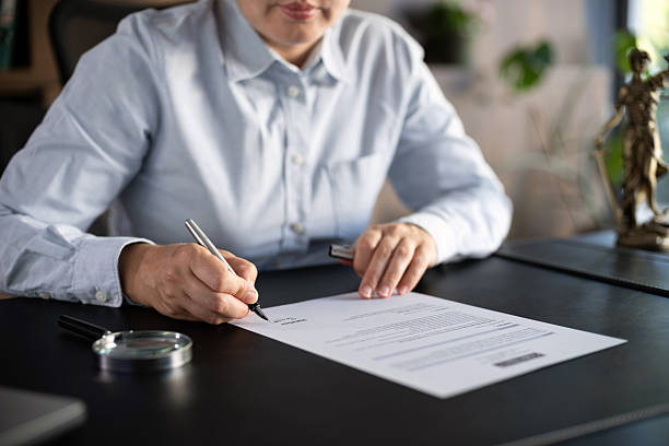 istock Lawyer signing an official document in the office 2239175043