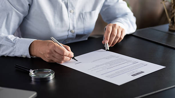 istock Lawyer signing an official document in the office 2239175149
