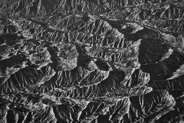 istock Black and White Aerial View of Eroded Folded Ridges in Dramatic Mountainous Terrain 2239176795