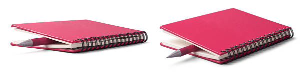 istock pink spiral notebooks with pen isolated white 2239178615