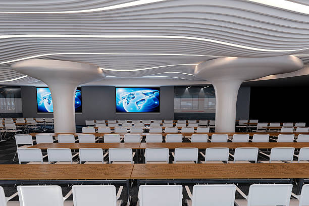 Spacious modern conference room with a large white table, laptops, and office supplies. Blank TV screen on a textured yellow wall. Business setting. 3D Rendering.