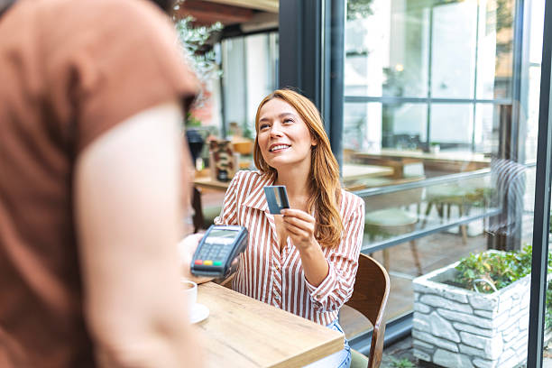 istock Female Client Settling Bill in Coffeehouse 2239184908