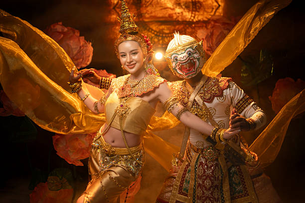 Traditional Thai dance performance featuring a graceful female dancer and a masked Khon performer in golden costumes, symbolizing elegance and cultural heritage