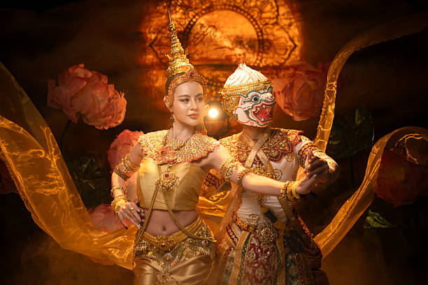 Traditional Thai dance performance featuring a graceful female dancer and a masked Khon performer in golden costumes, symbolizing elegance and cultural heritage