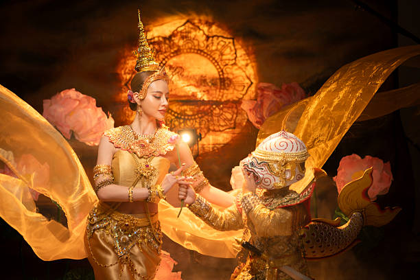 istock Traditional Thai dance performance featuring a graceful female dancer and a masked Khon performer 2239186756
