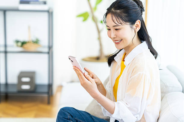 istock A woman operating a smartphone in the room 2239188012