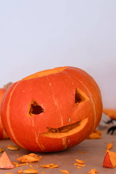istock Carved Halloween pumpkin with a smiling face displayed at home 2239190898