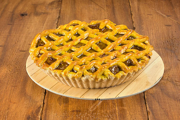 Apple pie in close-up on a rustic wooden background.