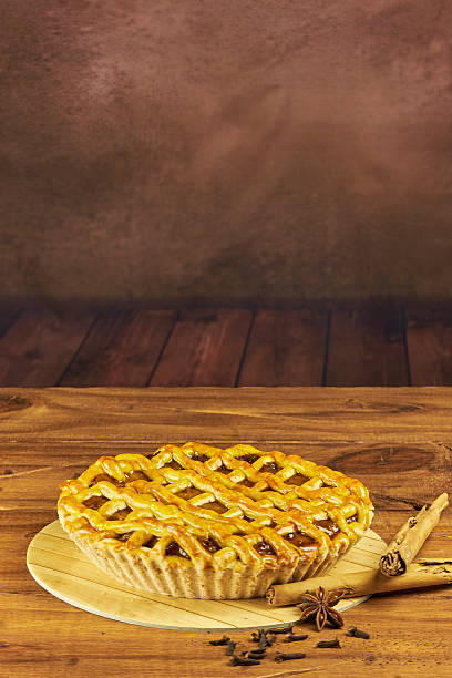 Apple pie in close-up on a rustic wooden background.