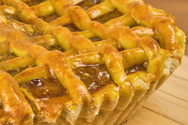 Apple pie in close-up on a rustic wooden background.