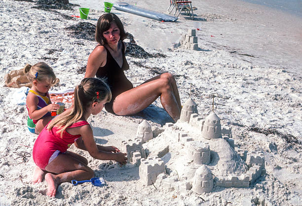 istock Clearwater FL - Mother & Daughters Work on Sandcastle - 1984 2239195575