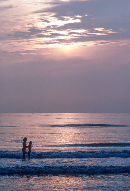 istock Clearwater FL - Mother & Daughter in Surf, Backlit - 1984 2239195617