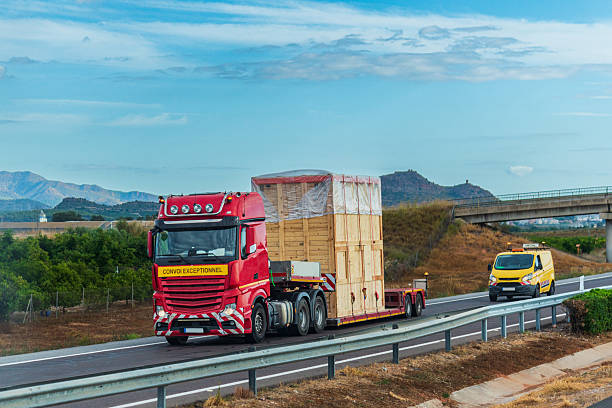 istock Truck transporting an oversized load escorted by a pilot vehicle, special transport 2239198265
