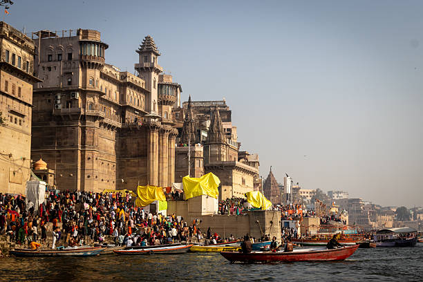 February 10, 2025, Banaras, India: A vibrant scene unfolds at Dashashwamedh Ghat in Varanasi, with crowds gathered on the riverfront steps and boats floating on the Ganges. The imposing heritage architecture rises behind the busy ghats, bathed in warm morning or evening light. This iconic ghat is central to the religious and cultural life of the city, reflecting daily rituals, pilgrim activity, and the timeless beauty of Kashi.