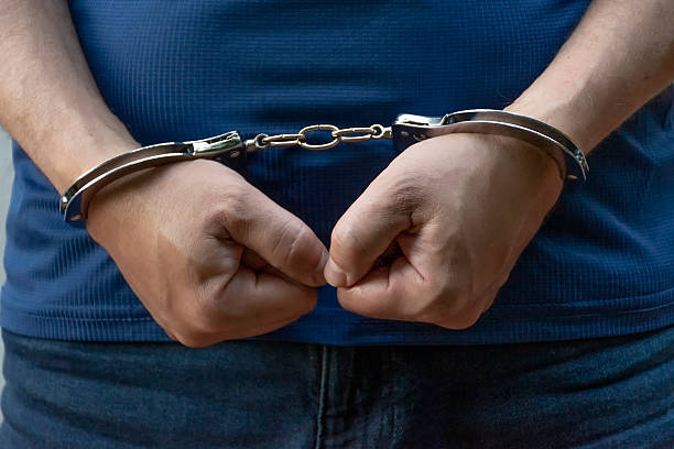 istock Hands in handcuffs close-up, police arrest scene 2239200160