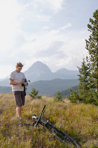 istock Young man prepares to fly drone in mountain meadow 2239204818