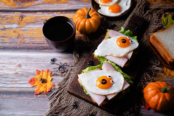 istock Sandwich with ham and fried egg in the form of ghost for Halloween holidays 2239215565