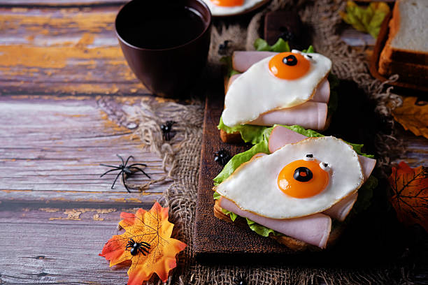 istock Sandwich with ham and fried egg in the form of ghost for Halloween holidays 2239215567