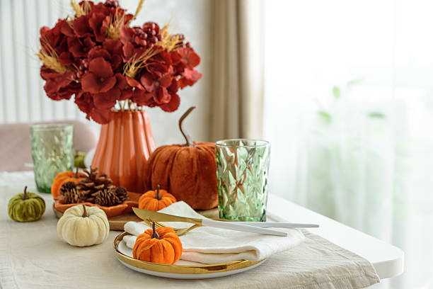 istock Thanksgiving table setting with decorative pumpkins, candles and string lights on white wooden table 2239216742