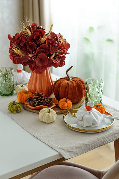 istock Thanksgiving table setting with decorative pumpkins, candles and string lights on white wooden table 2239216759