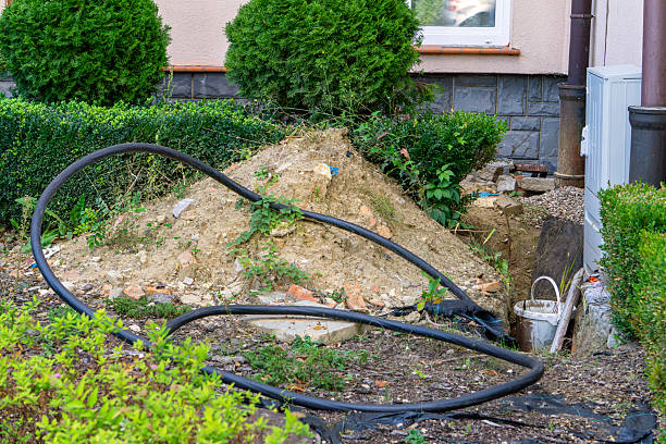 istock Excavation near building with visible pipe and installation cable, earthworks by facade and electrical box. 2239218466