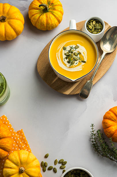 istock Homemade pumpkin cream soup in a bowl, bright background 2239220596
