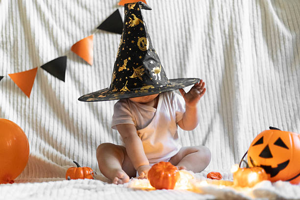 istock Cute Child with Halloween Pumpkin in Witch Hat 2239220911