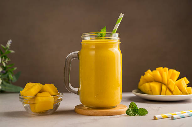 istock Mango banana smoothie in a glass mug with fresh fruit and mint 2239223826