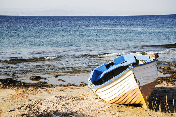 A landscape of a beautiful summer sea with a boat on the shore
