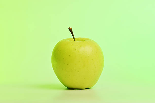 istock A green apple sits on a light green background 2239226882