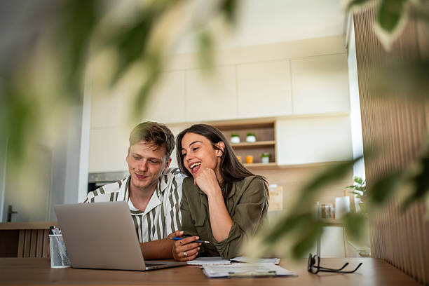 istock Young couple planning finances online using laptop at home 2239228919