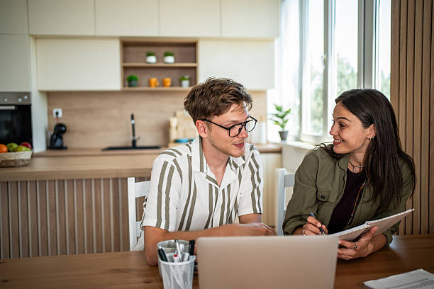 istock Young couple studying together at home kitchen table 2239229020