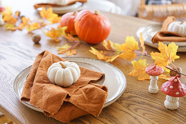 istock Autumn, fall, Halloween or Thanksgiving festive day table setting with yellow leaves and pumpkins 2239233463